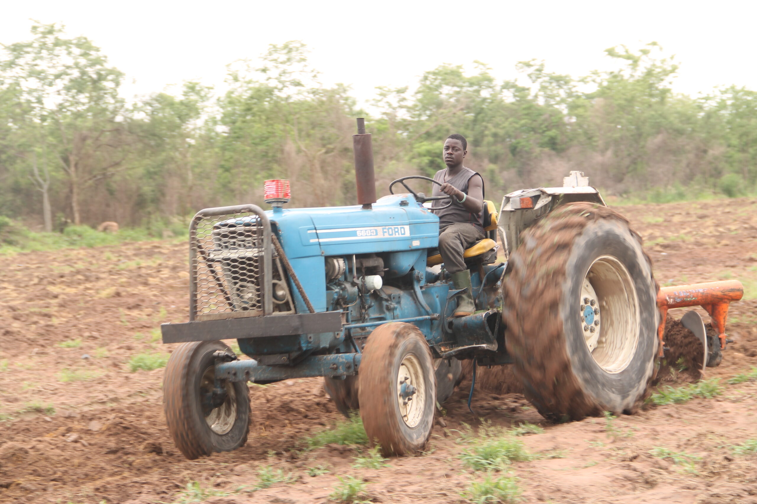 A tractor ploughing farmland in Ghana