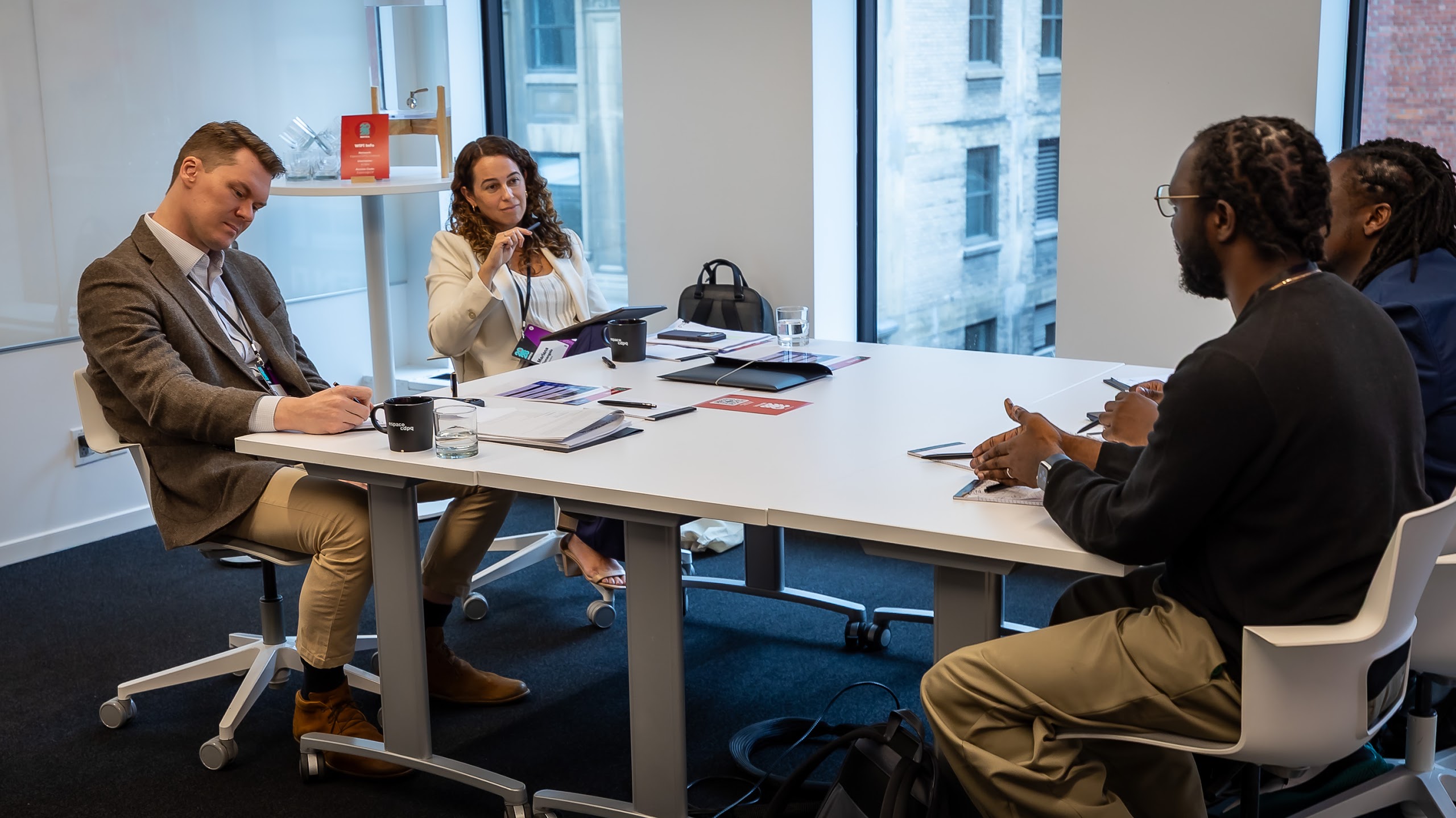 Two panelists seated at a table listening to entrepreneurs during a selection session in Montreal